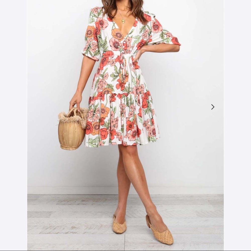 Never worn with tags, the Quarelle Dress is an above the knee, v-neck dress.